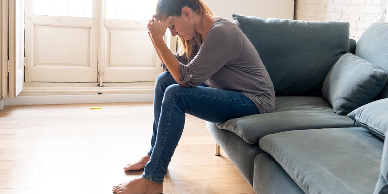 A woman having headaches touching her forehead in pain