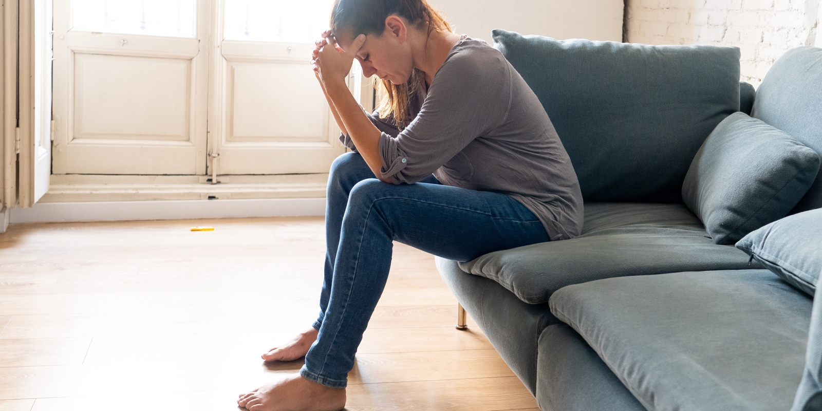 A woman having headaches touching her forehead in pain